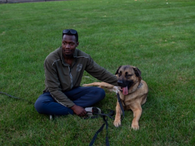 Mo sitting with German Shepherd, K9 Obedience Academy Rochester NY